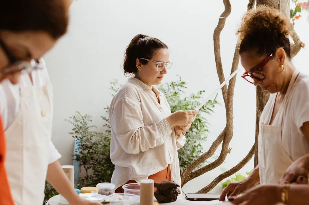 Adults shaping clay at a pottery workshop