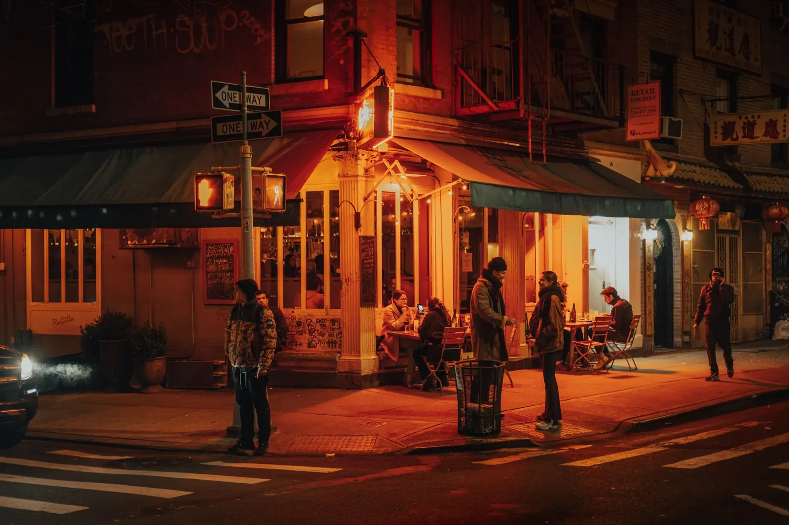 A cozy New York restaurant lit up at night with people dining