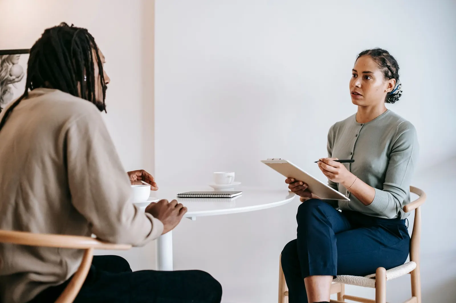 An interviewer taking notes during a one-to-one conversation
