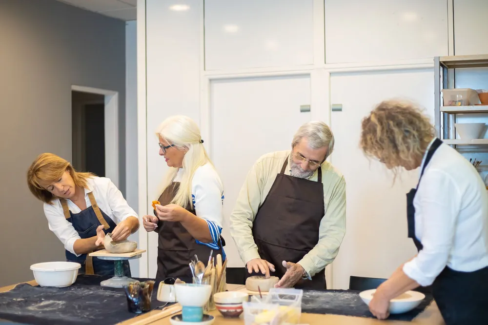 A group of adults at a pottery class