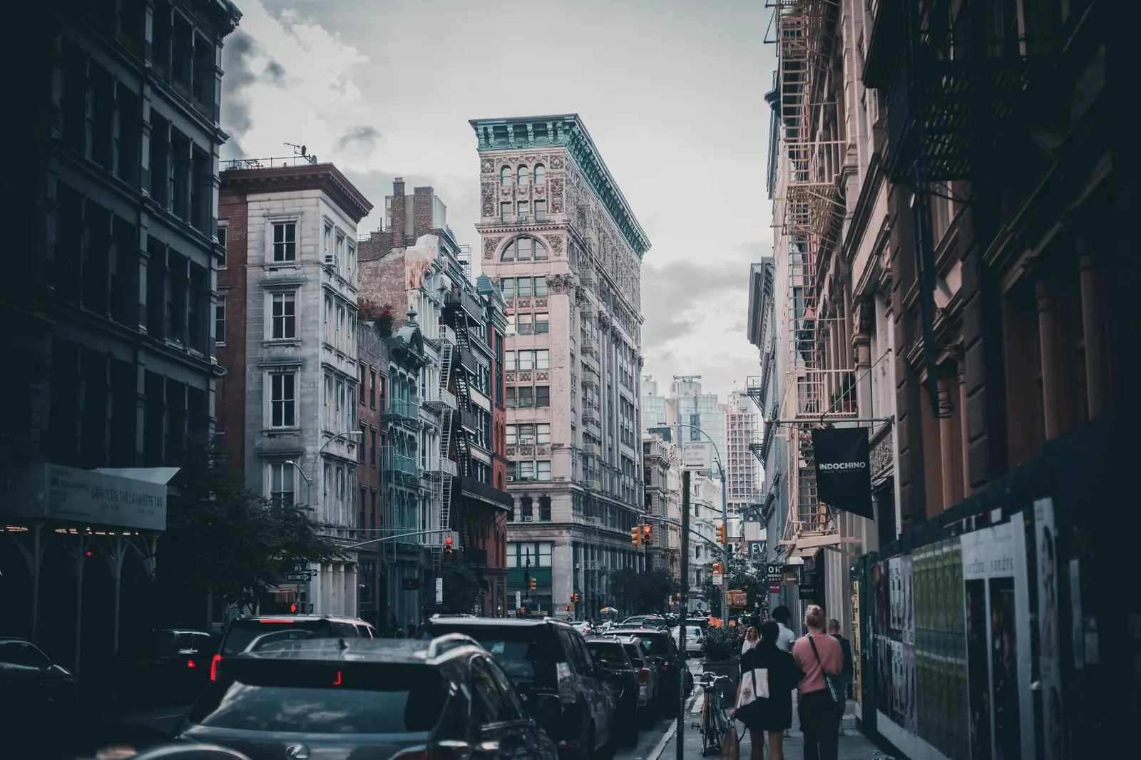Pedestrians and traffic on a street of cast-iron buildings in SoHo, New York
