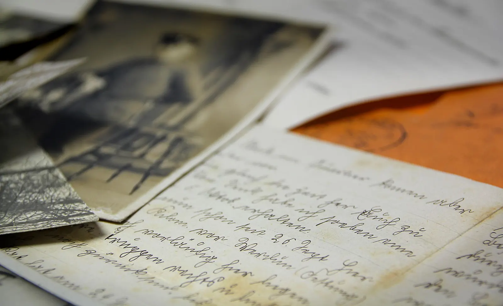 Old handwritten letters and vintage photographs on a table